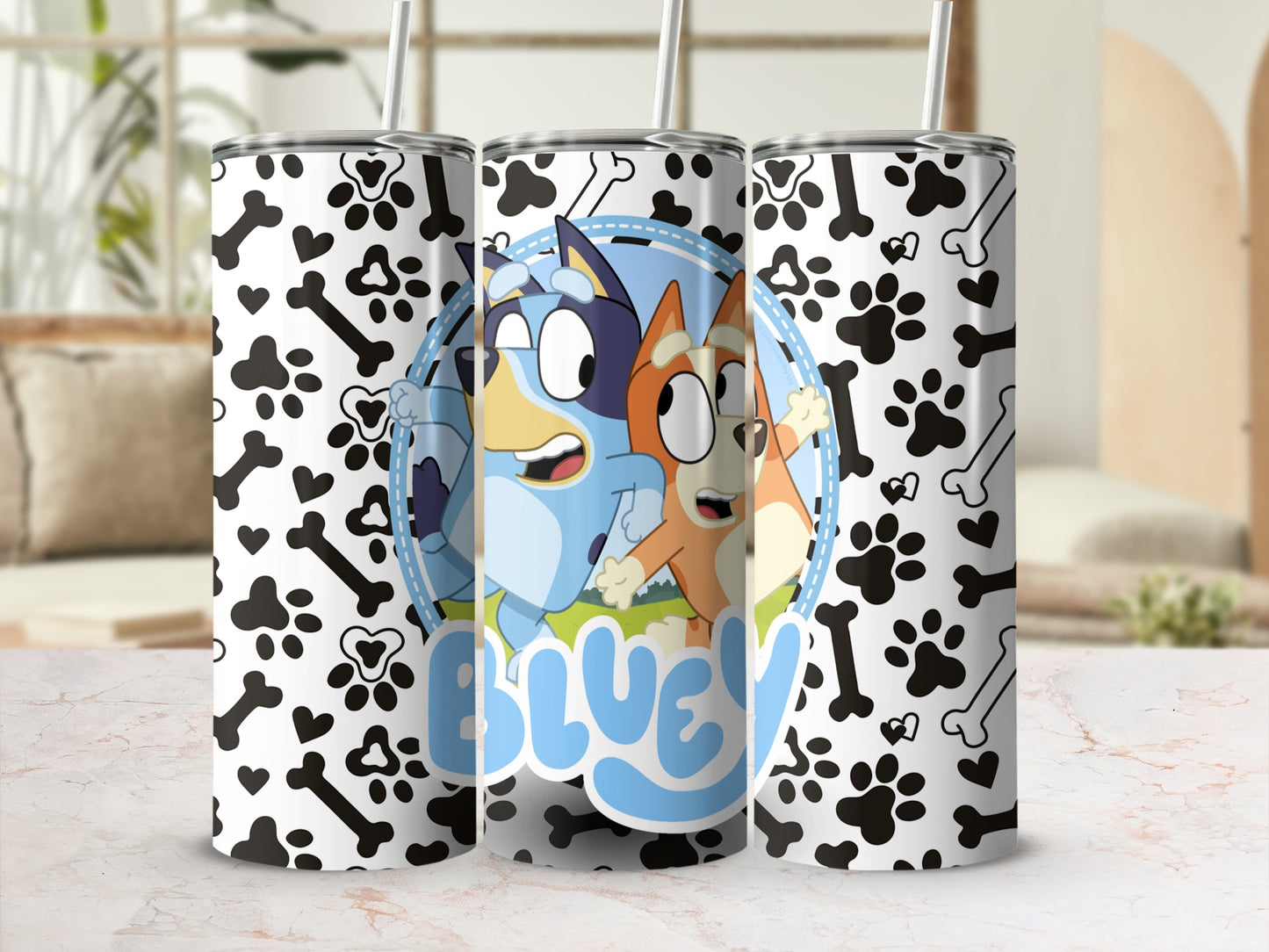Bluey and Bingo characters on a white tumbler with paw print and bone pattern.