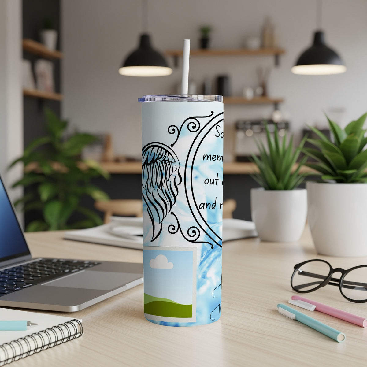Tumbler with angel wings, a photo frame, and text on a blue background.