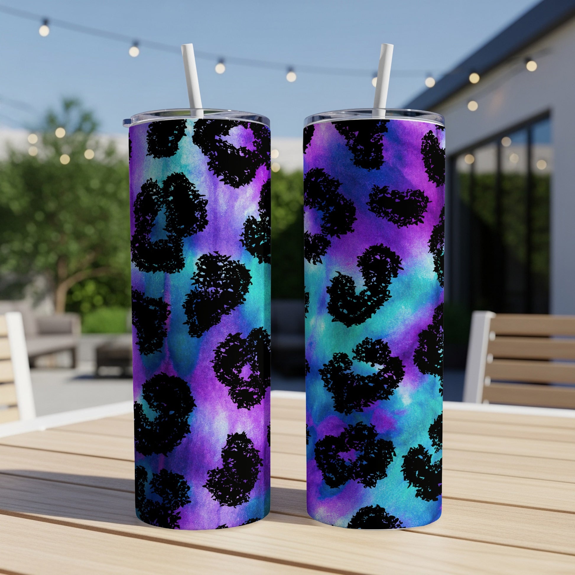 Two tumblers with a purple and teal watercolor background and black leopard print hearts.