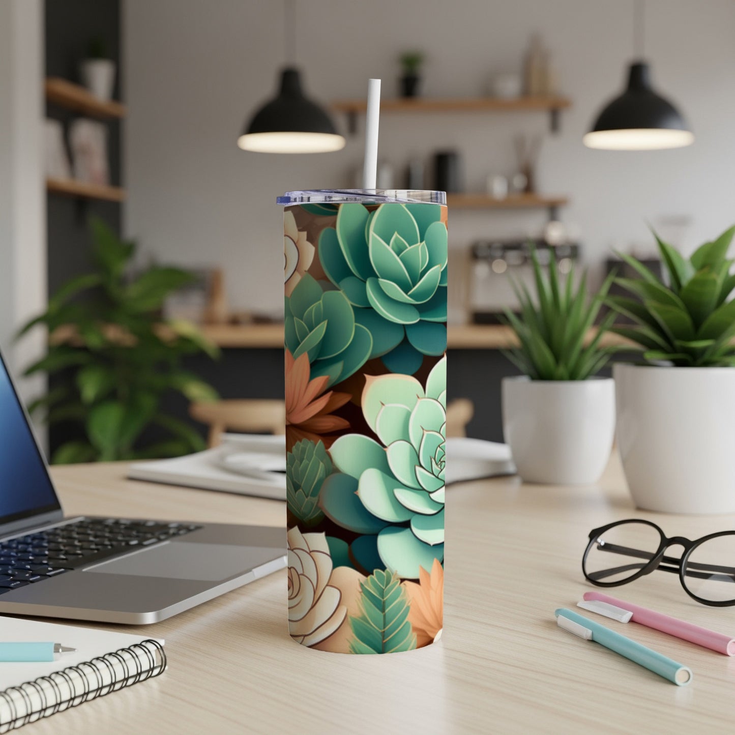 Succulent plant pattern on a white tumbler with a straw.