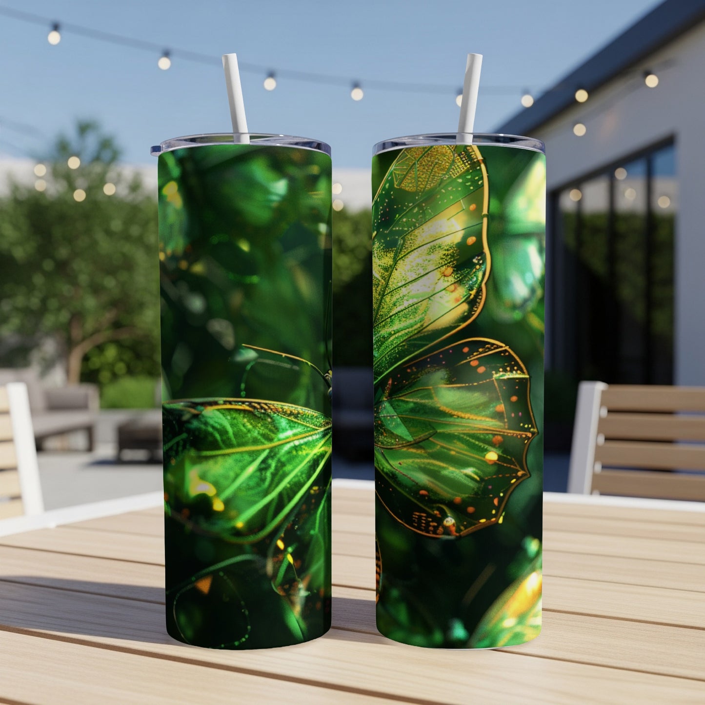 Two tumblers with a golden green butterfly design on a wooden table.