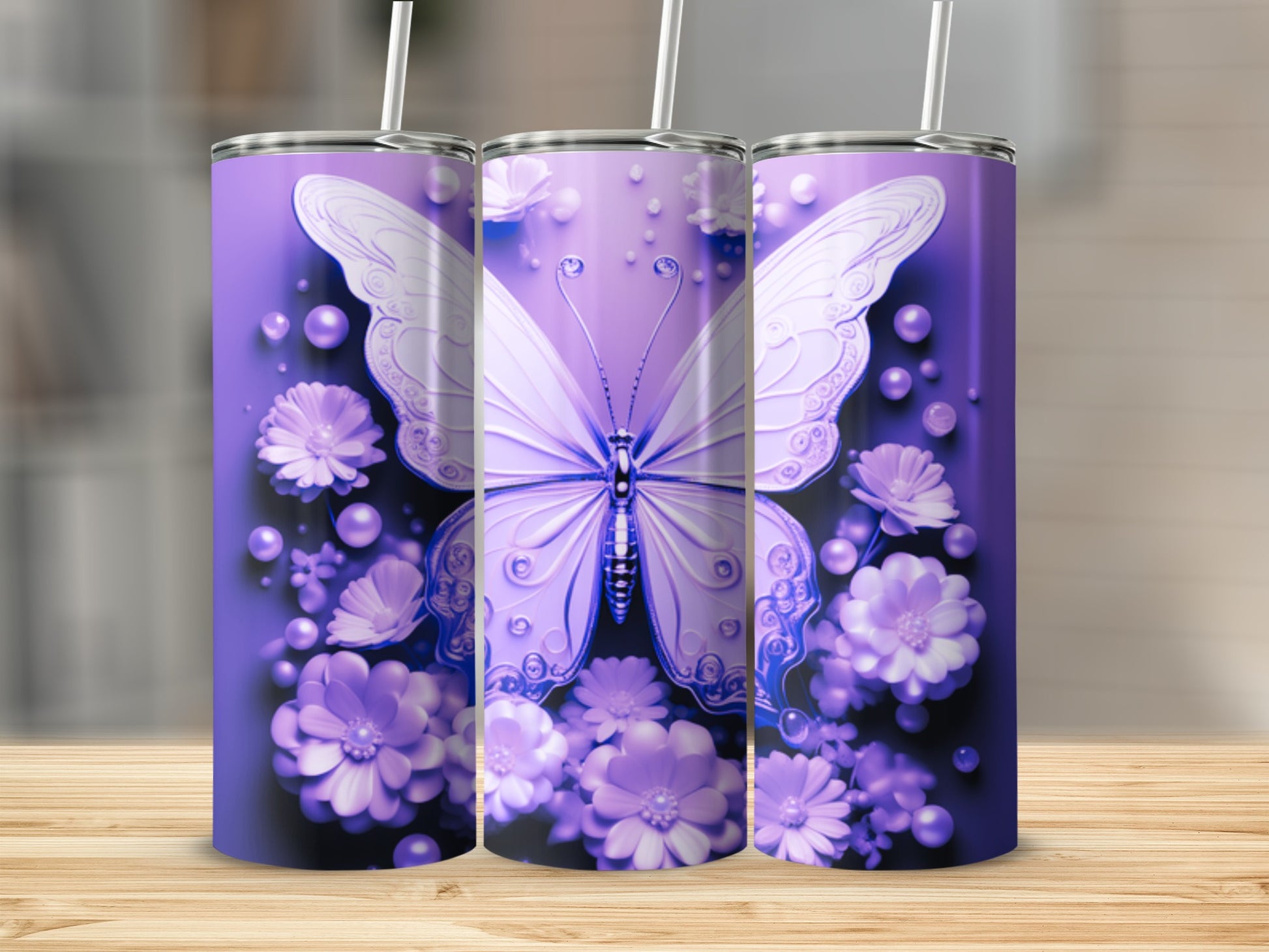 Three purple tumblers with butterfly and floral designs on a wooden surface.