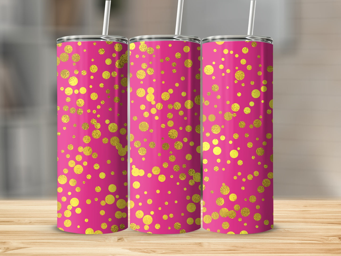 Three pink tumblers with scattered gold polka dots and straws.