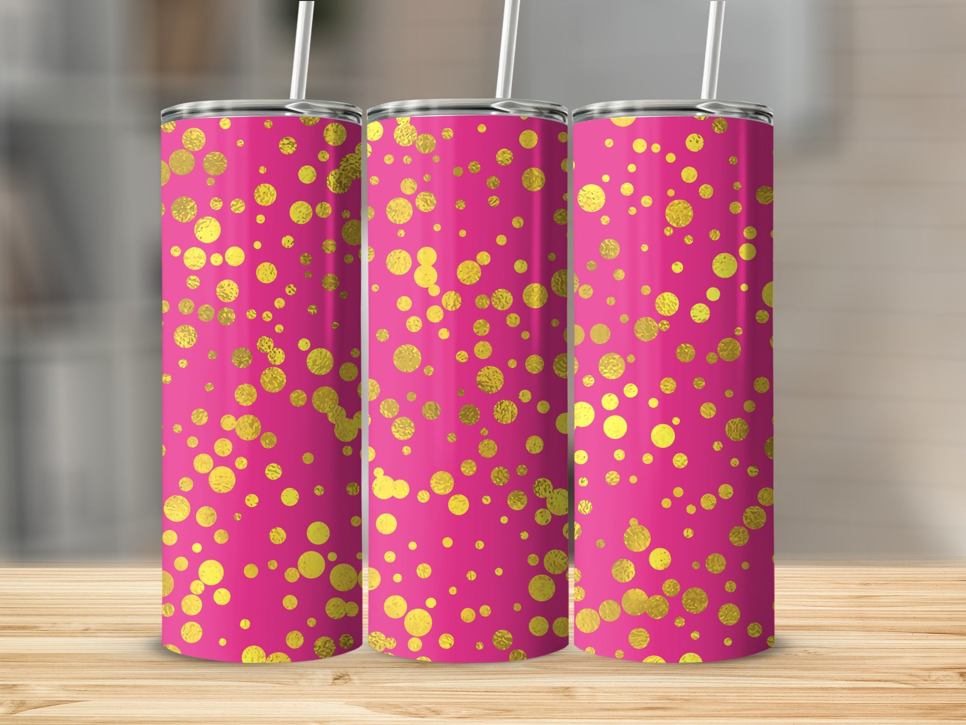 Three pink tumblers with scattered gold polka dots and straws.