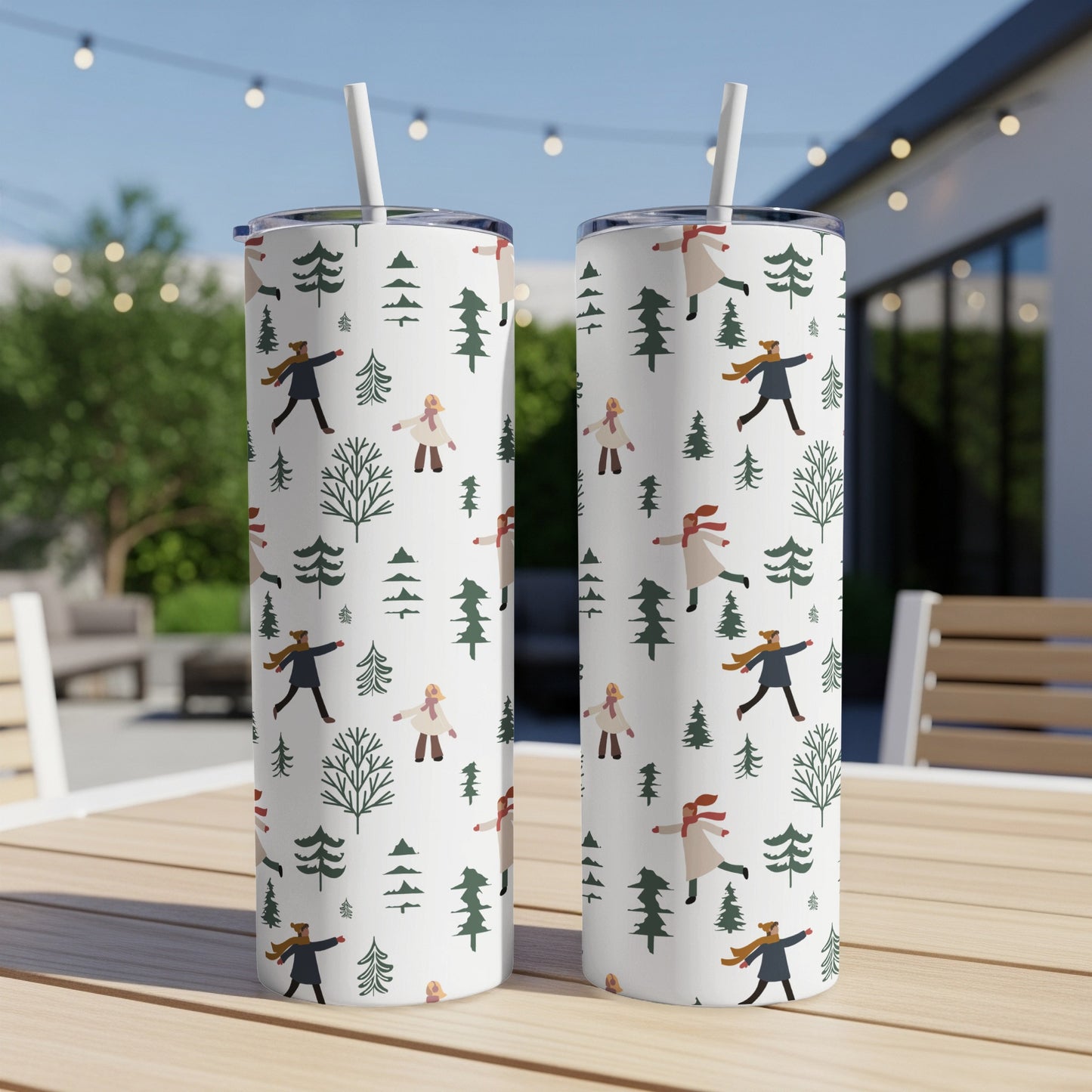 Two white tumblers with a repeating pattern of stylized winter figures and trees.