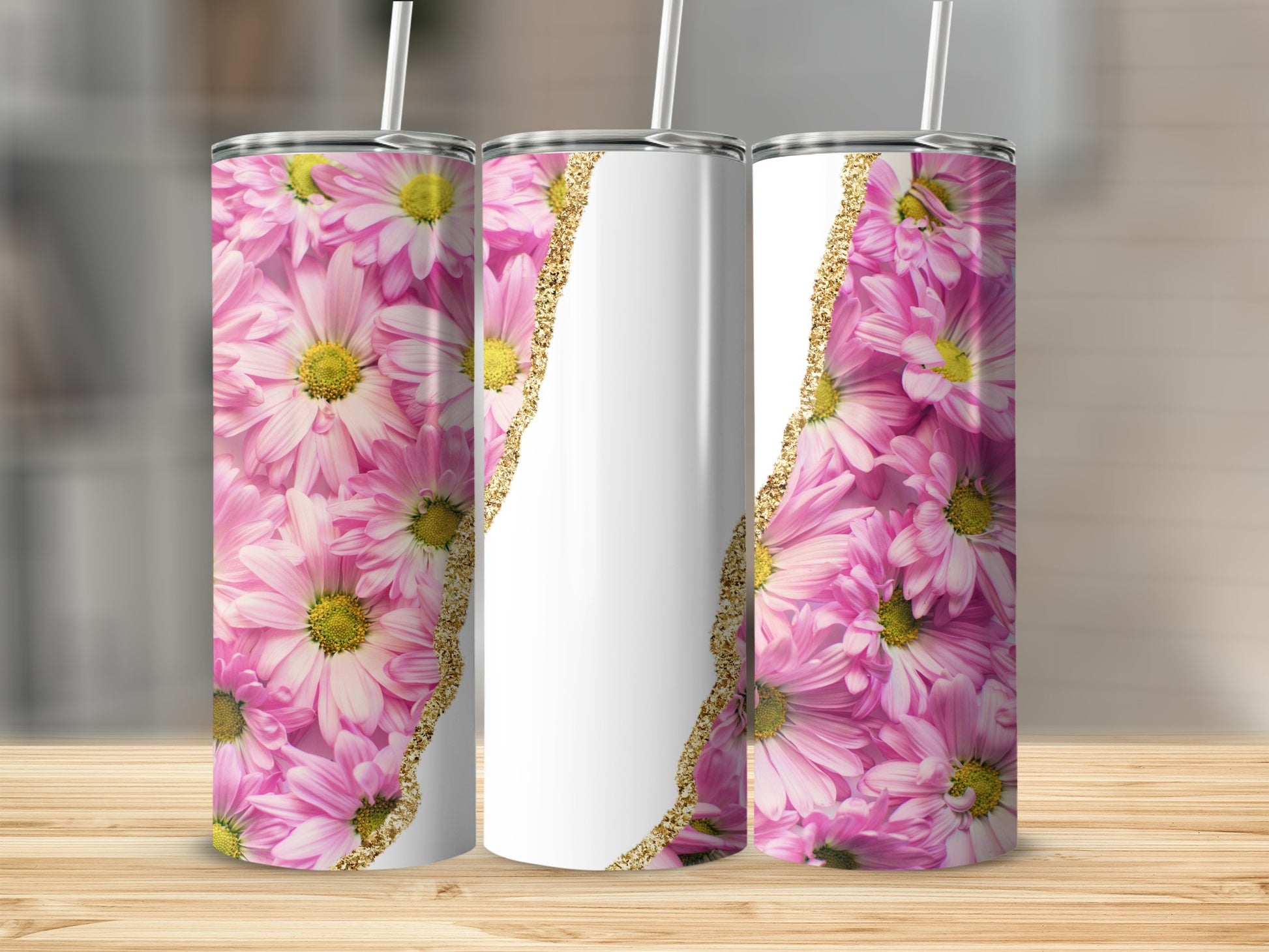 Three tumblers with pink floral designs and gold glitter accents.