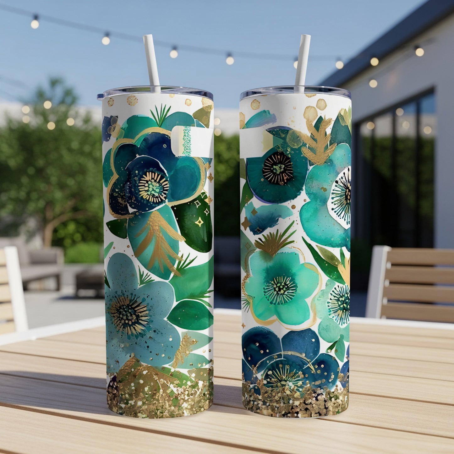 Two tumblers with a floral design of teal and gold flowers and leaves.
