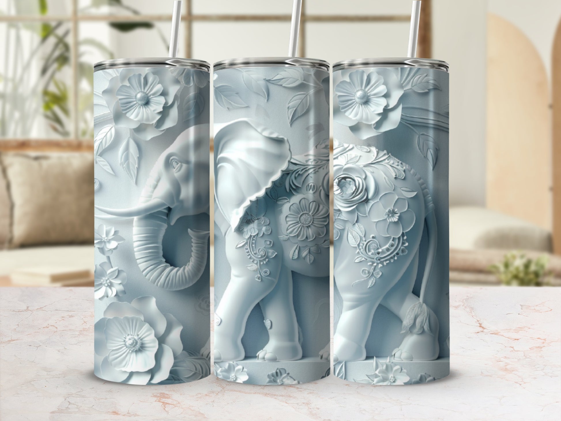 Three white tumblers featuring embossed elephants and floral designs.