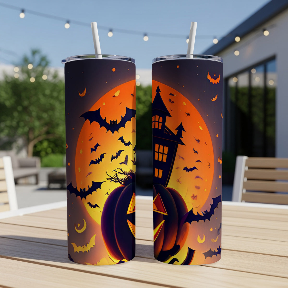 Two tumblers with Halloween theme featuring pumpkins, bats, and a haunted house.
