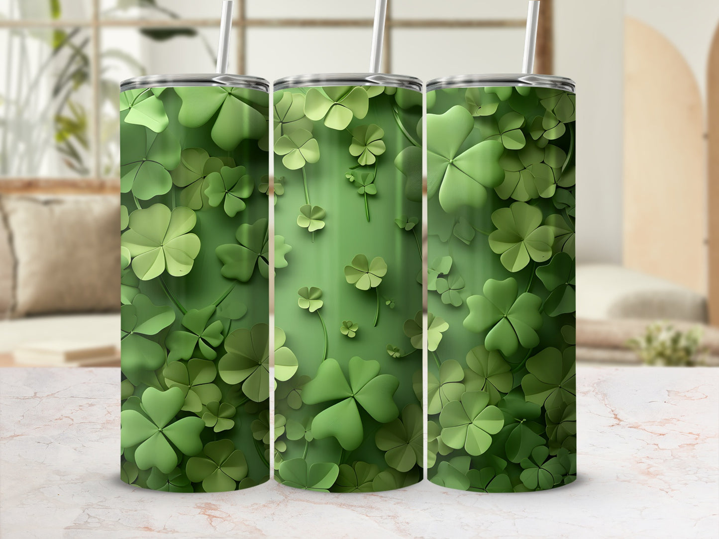 Three green tumblers with a shamrock pattern on a marbled surface.