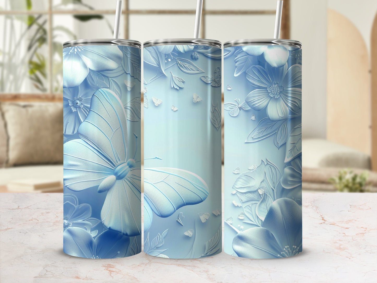 Three light blue tumblers with embossed butterfly and floral designs.