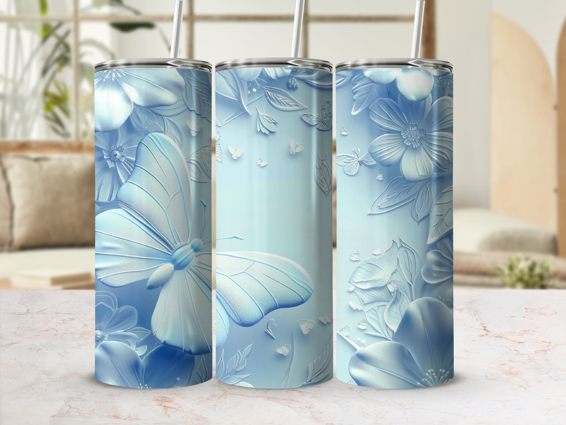 Three light blue tumblers with embossed butterfly and floral designs.