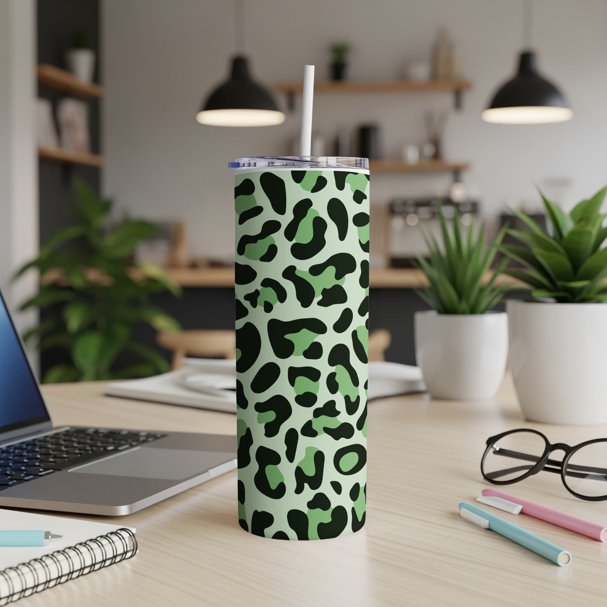 Tall green tumbler with black and light green leopard print and white straw.