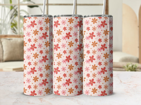 Three tall tumblers with a repeating pattern of small pink and orange flowers.