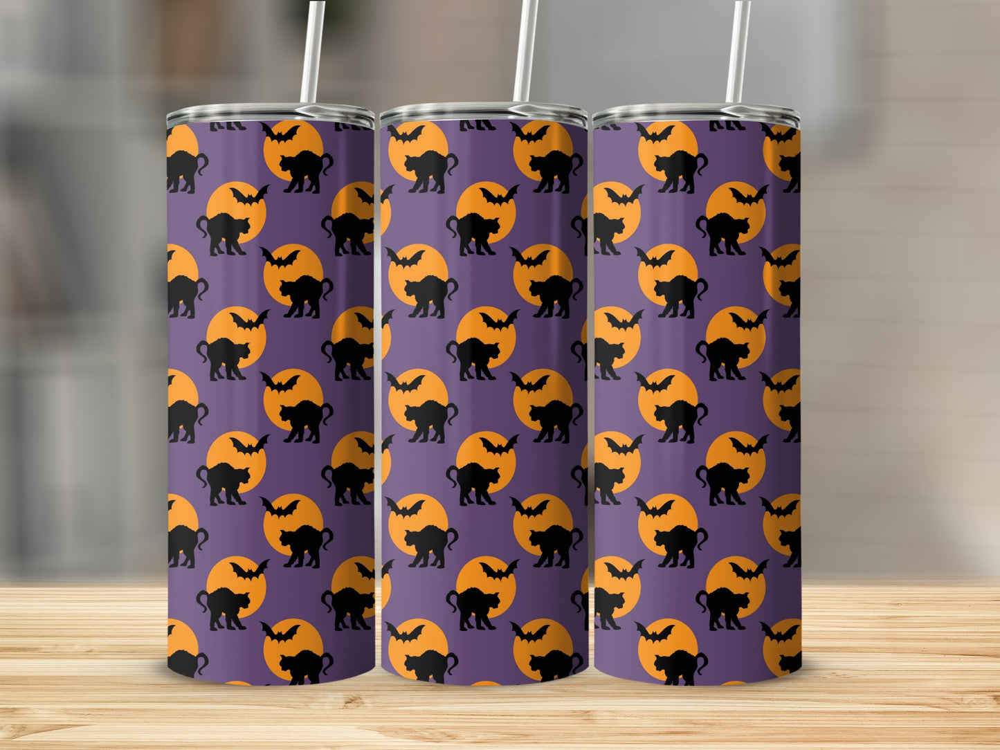 Three tumblers with a Halloween pattern of black cats, bats, and orange moons on purple.