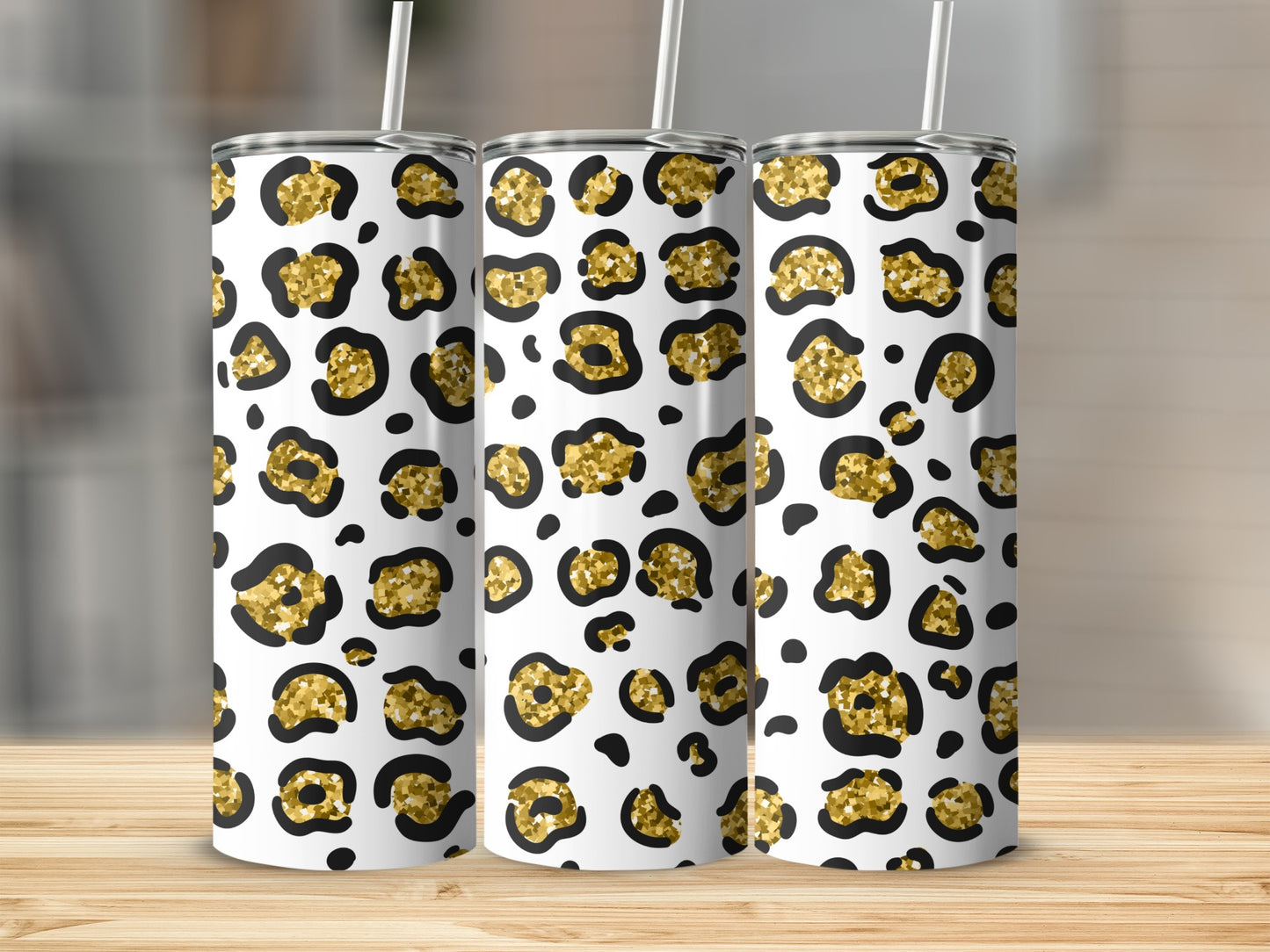 Three tumblers with a white background and a gold and black leopard print pattern.