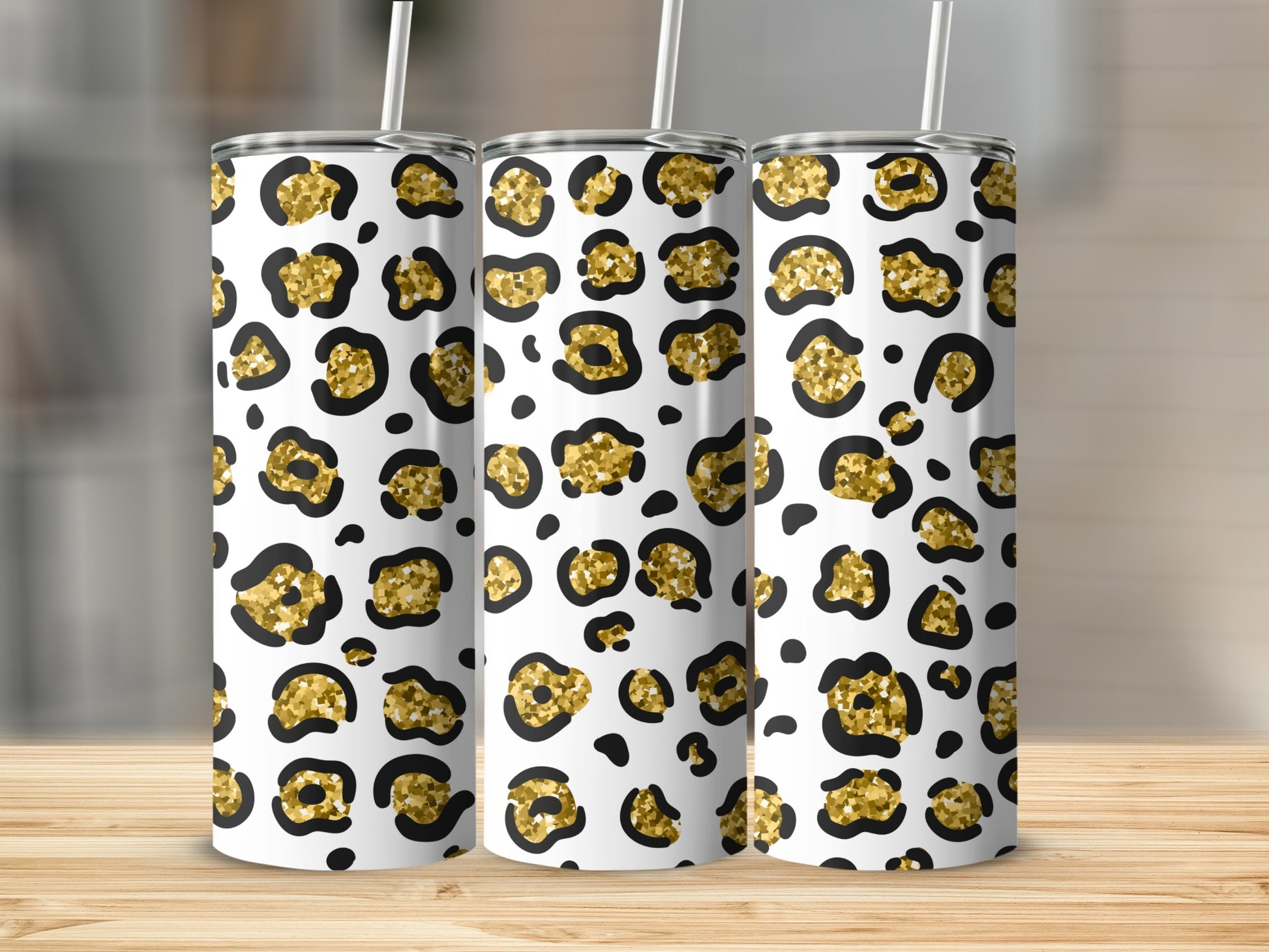 Three tumblers with a white background and a gold and black leopard print pattern.