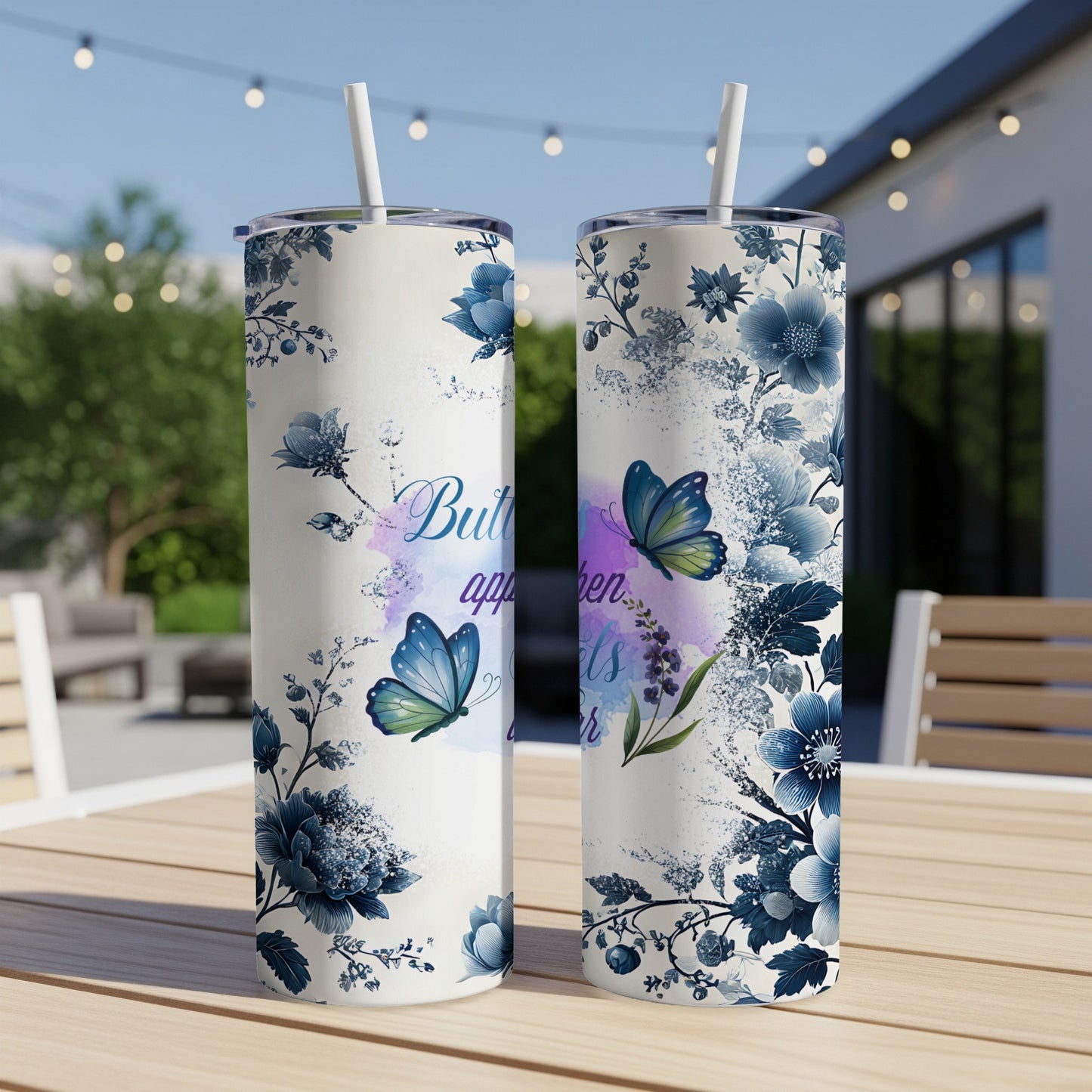 Blue floral and butterfly design on a white tumbler with straw.