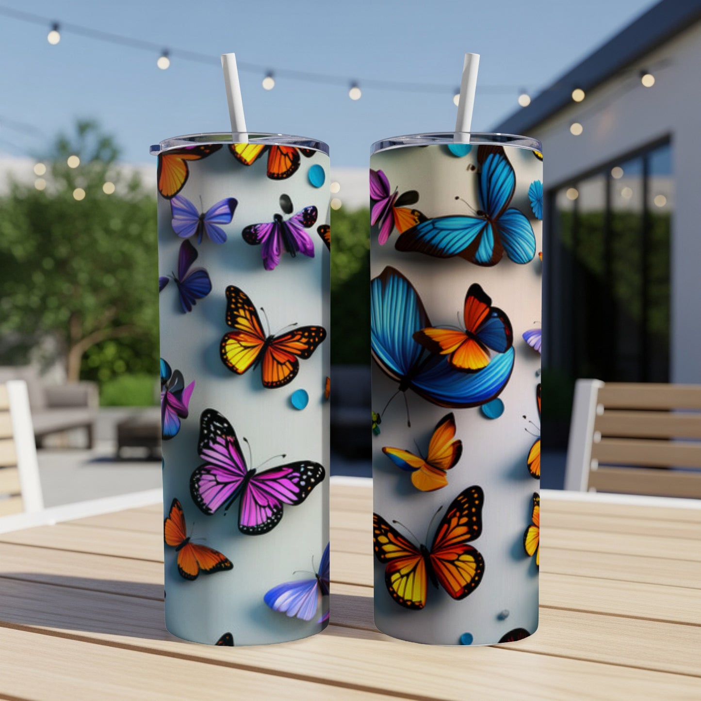 Two tall tumblers with colorful butterfly designs sit on a wooden table.