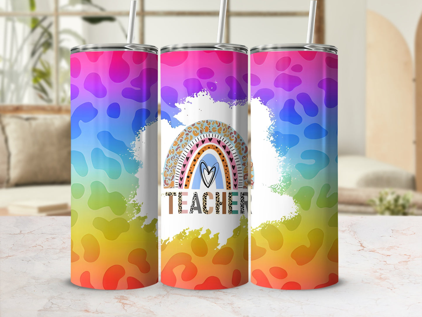 Rainbow tie-dye tumbler with "Teacher" text and heart.
