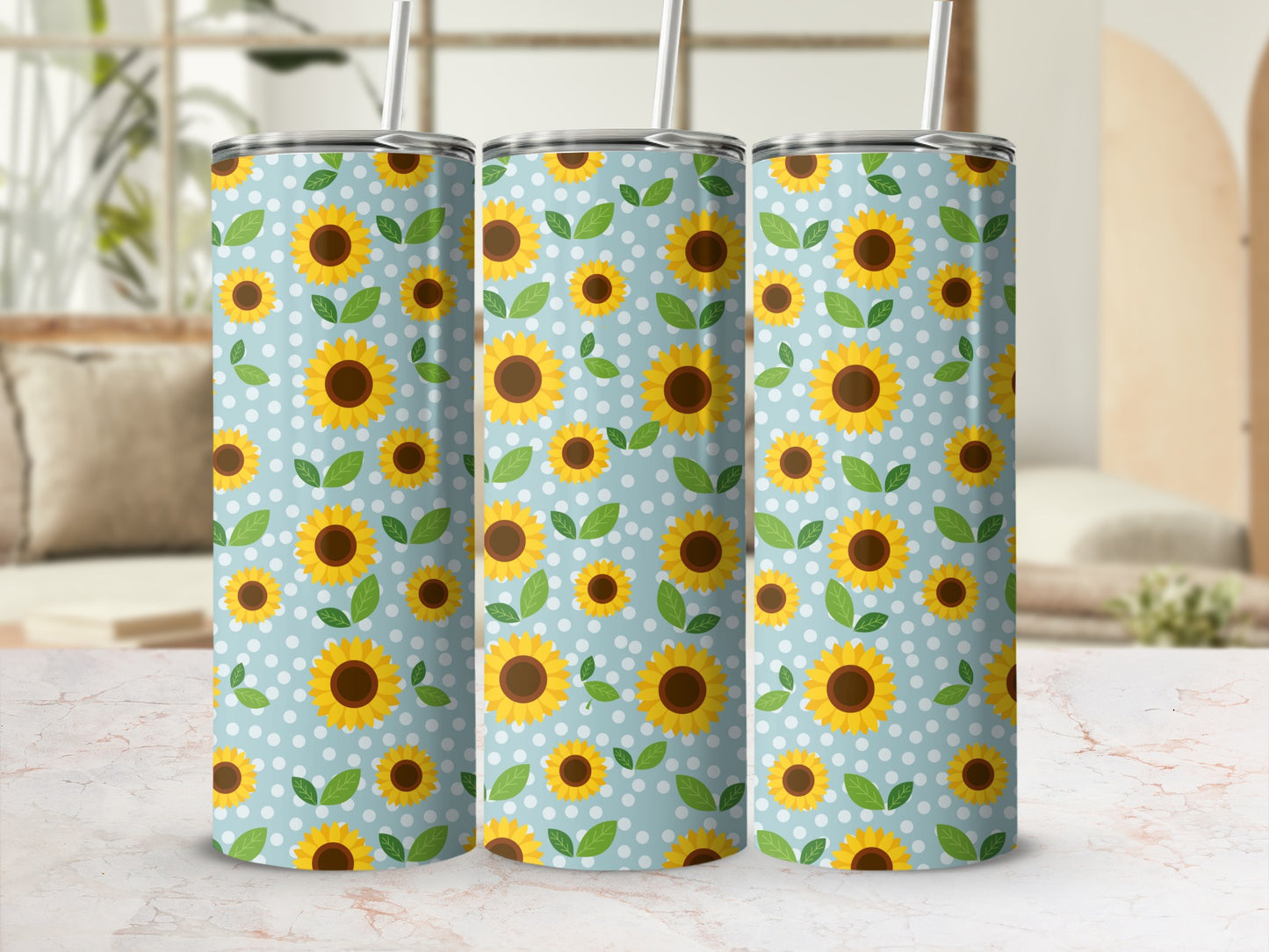 Three tumblers with a blue background and white polka dots, decorated with sunflowers and leaves.