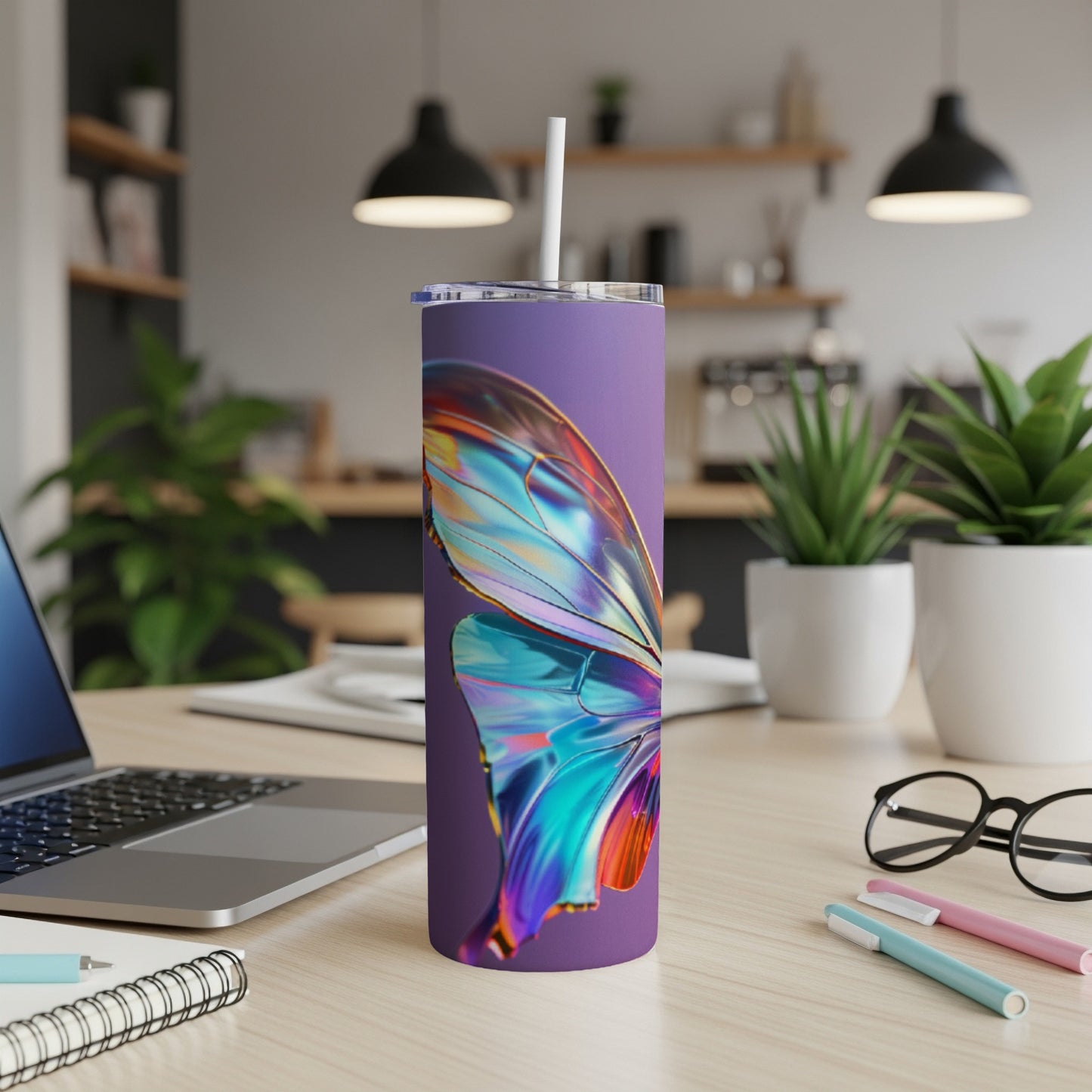Purple tumbler with iridescent butterfly wing design on a desk.