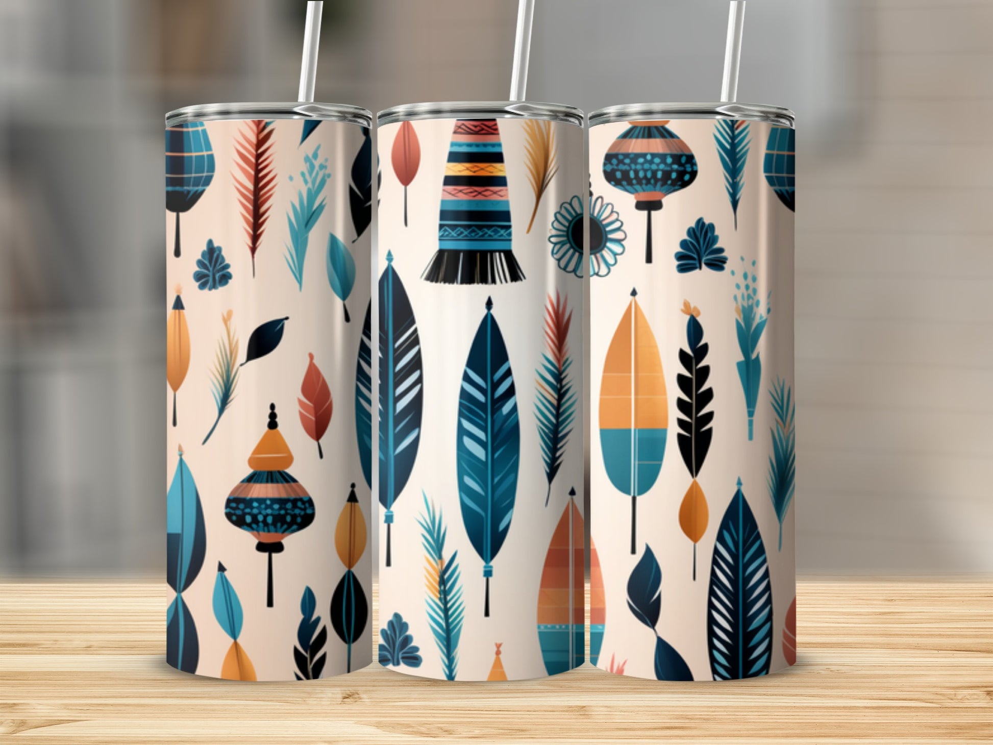 Three tumblers with feather and lantern pattern on a wooden surface.