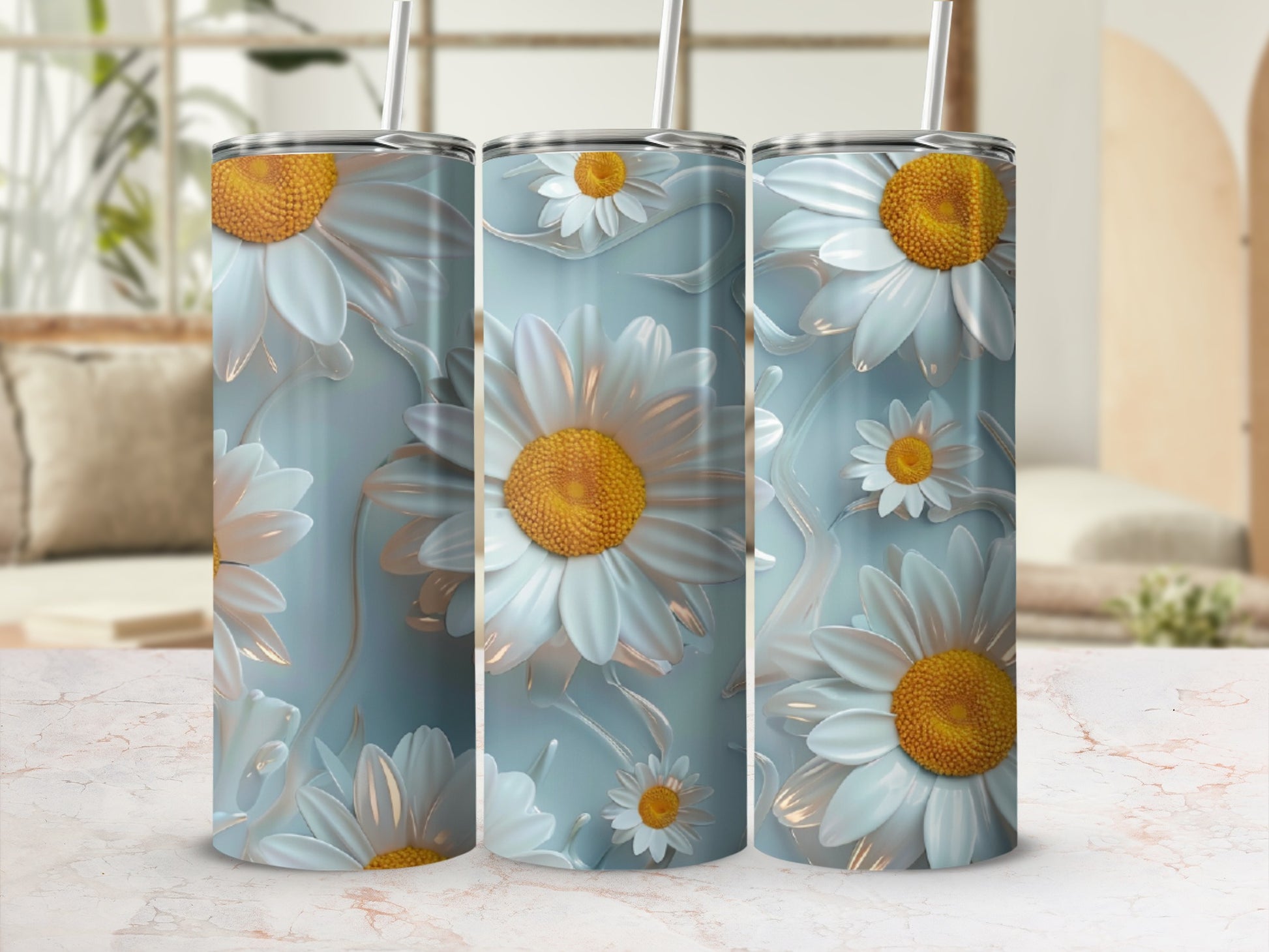 Three tumblers with a daisy flower design on a marbled surface.