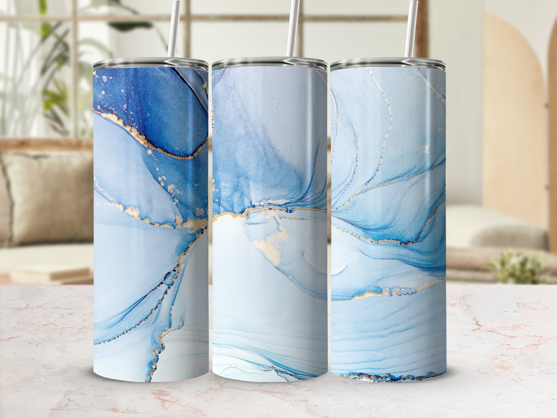 Three tumblers with blue and gold abstract marble pattern, straw.