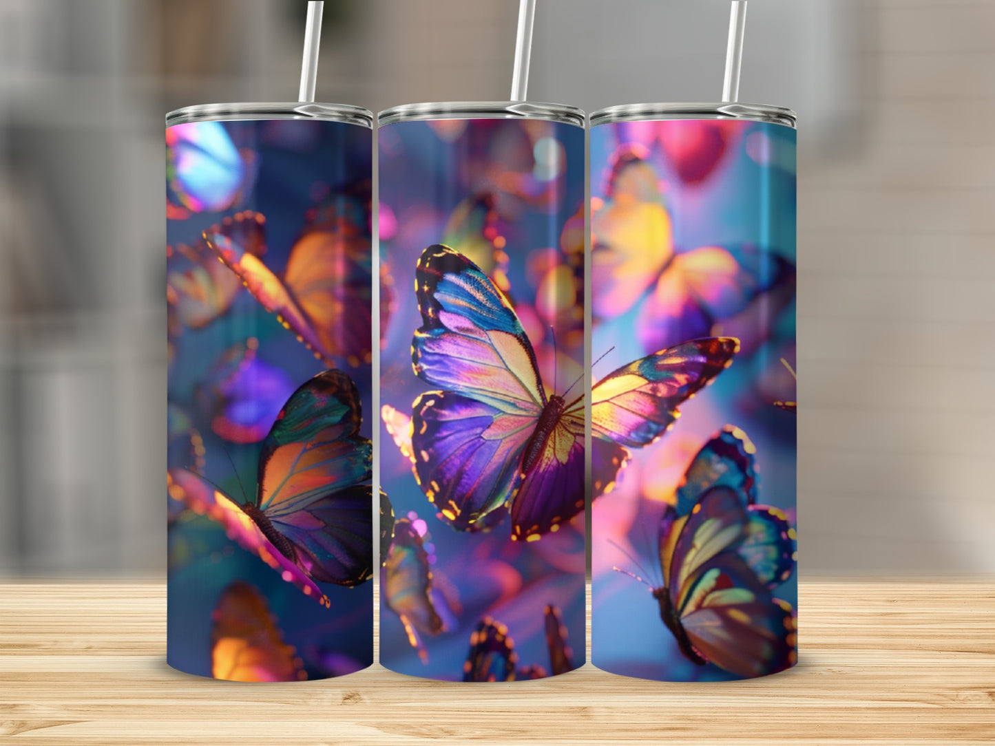 Three tumblers with iridescent butterfly designs, set against a bokeh background.