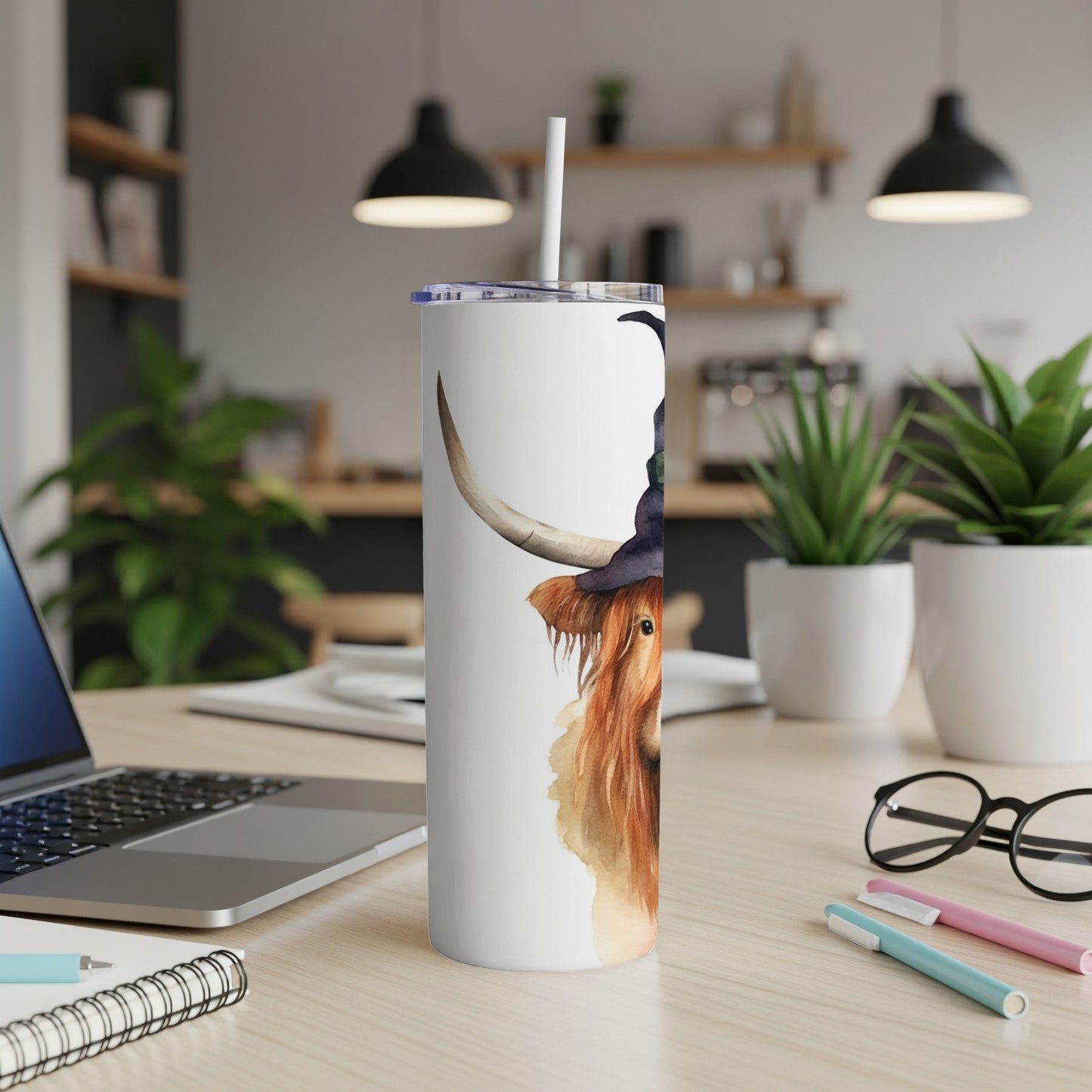 Watercolor Highland cow wearing a witch hat on a white tumbler.