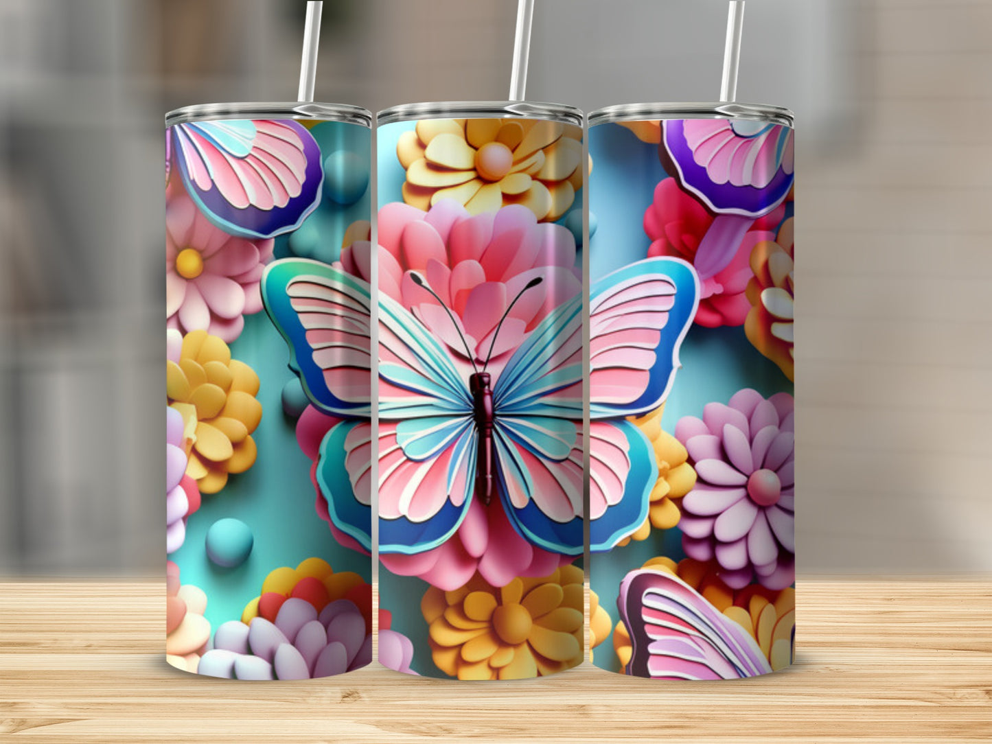 Three tumblers featuring a teal butterfly and colorful floral designs.