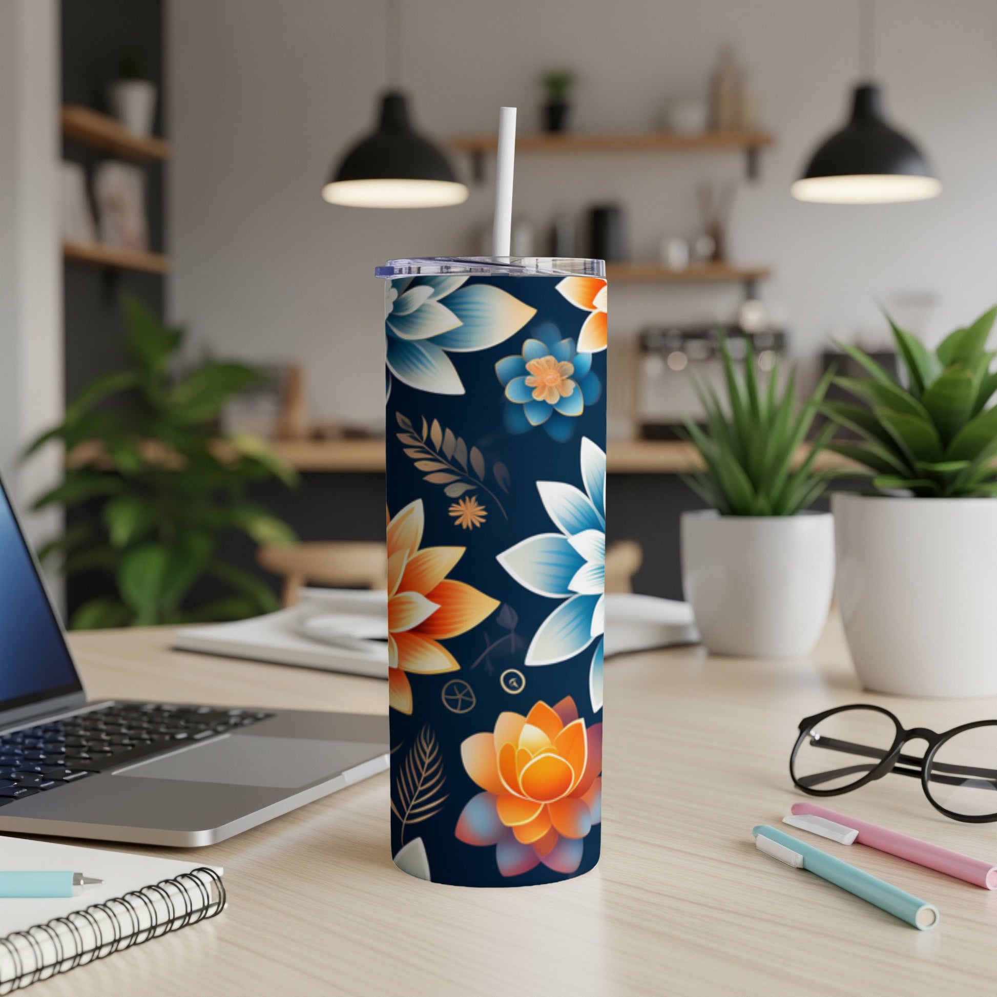 Navy blue tumbler with colorful floral designs, lid, and straw.