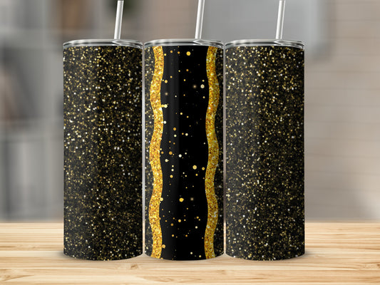Three glitter-covered tumblers with gold accents on a wooden surface.