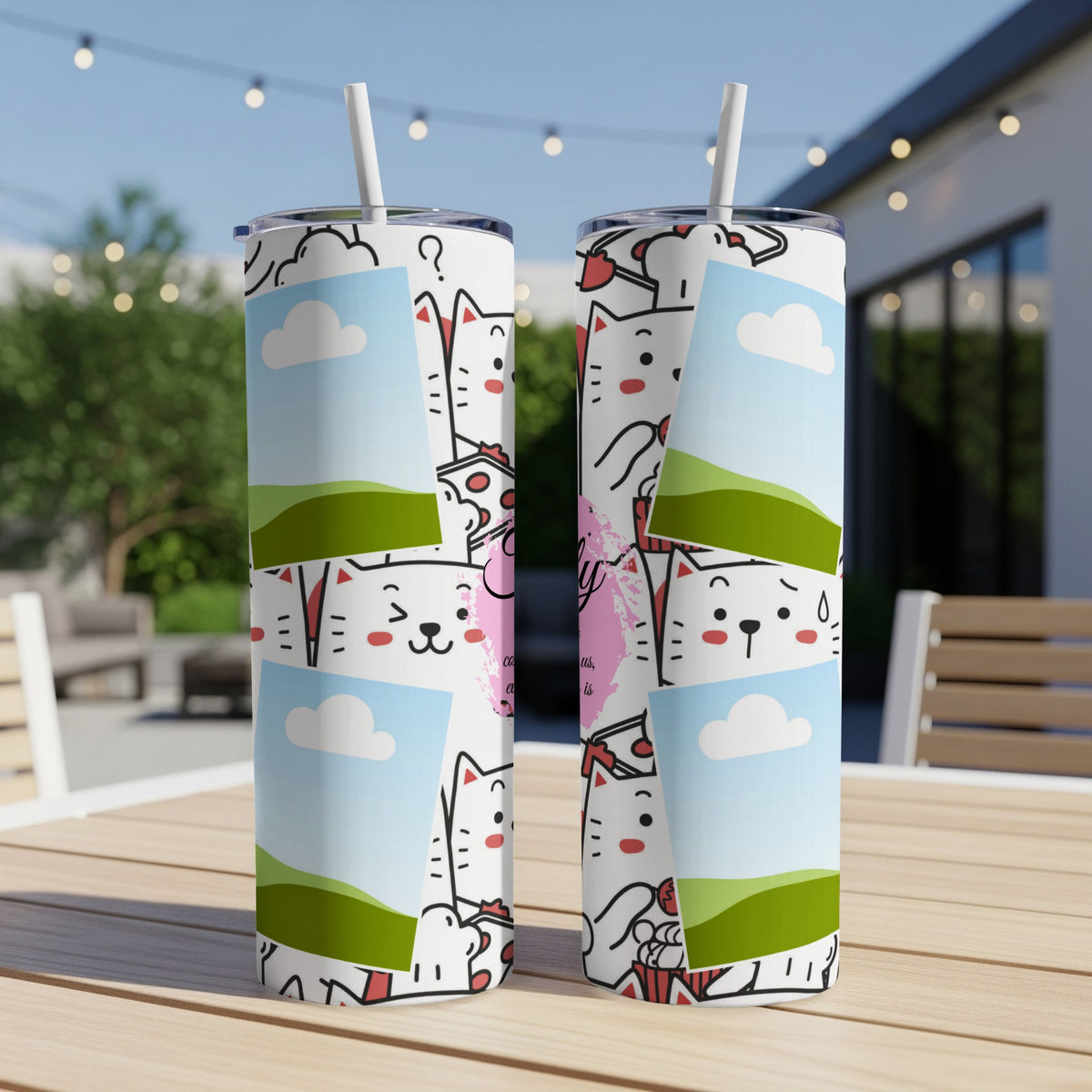 Two white tumblers with a cartoon cat design and framed sky photos.