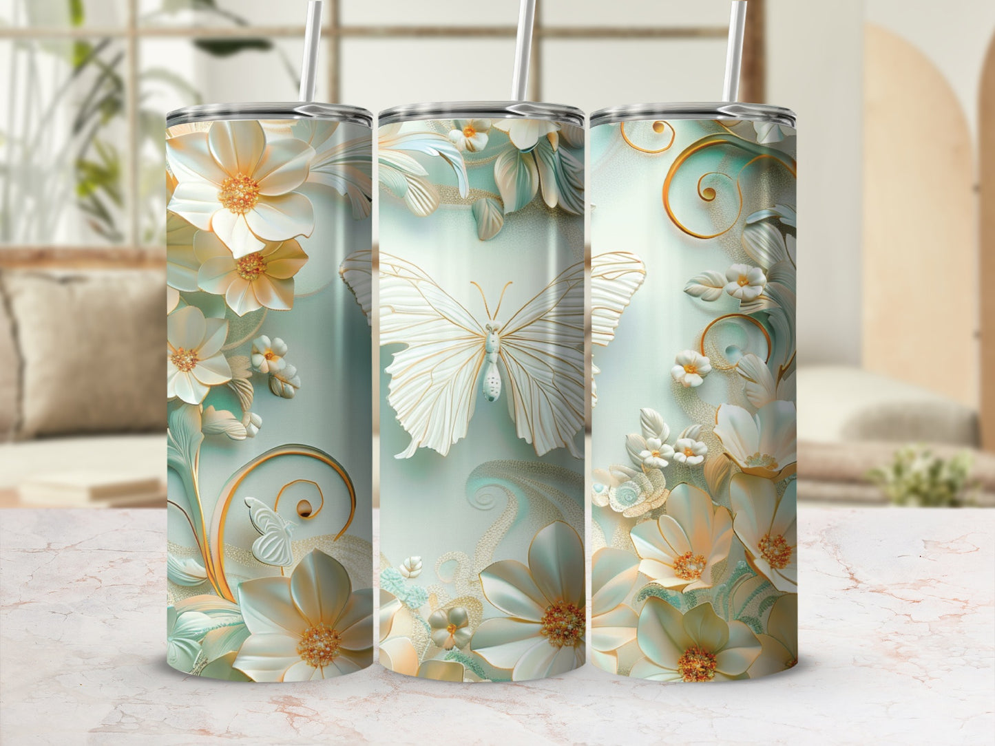 Three tall tumblers with white butterflies and ornate floral designs on a light mint background.