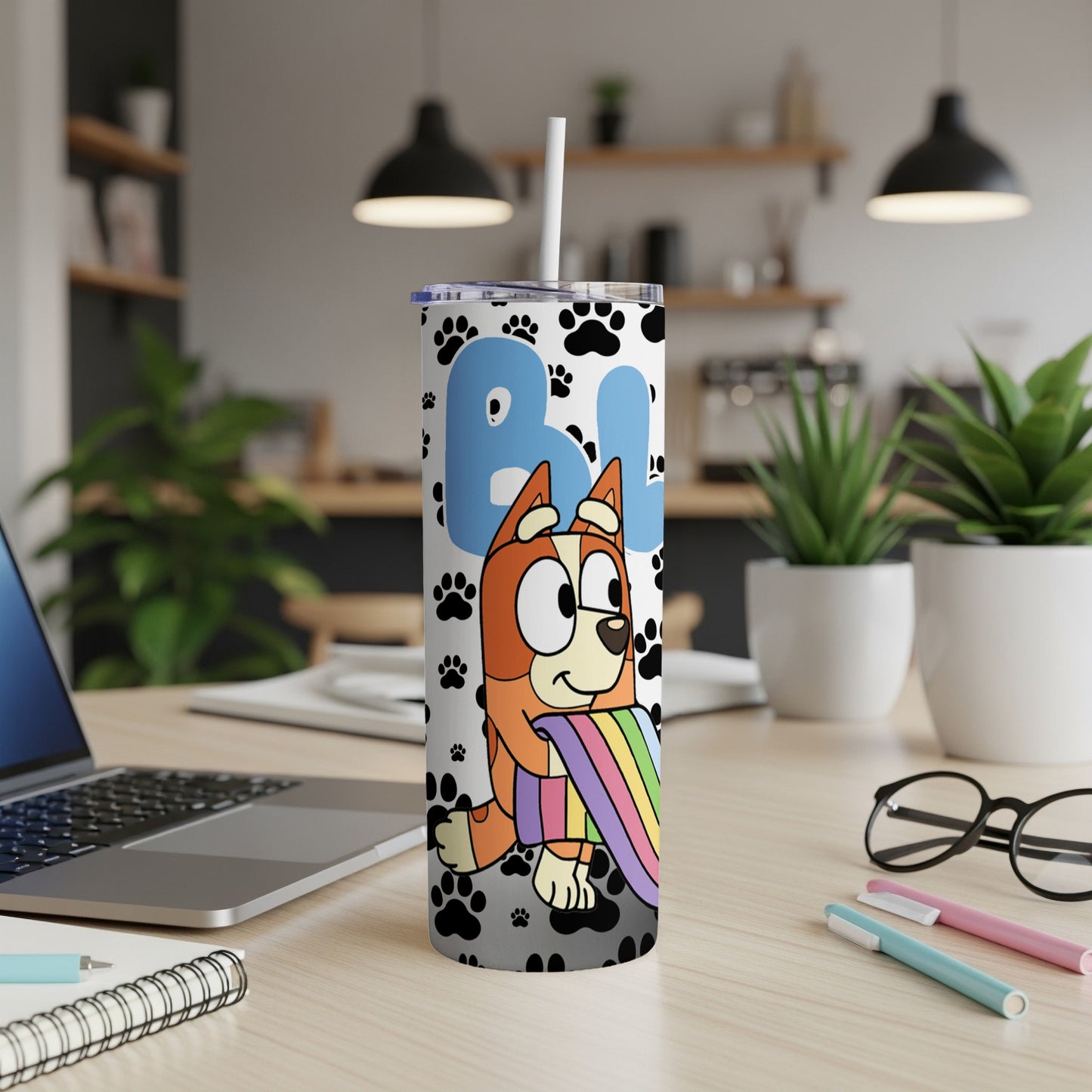 Bluey character with rainbow, paw prints on a white tumbler.