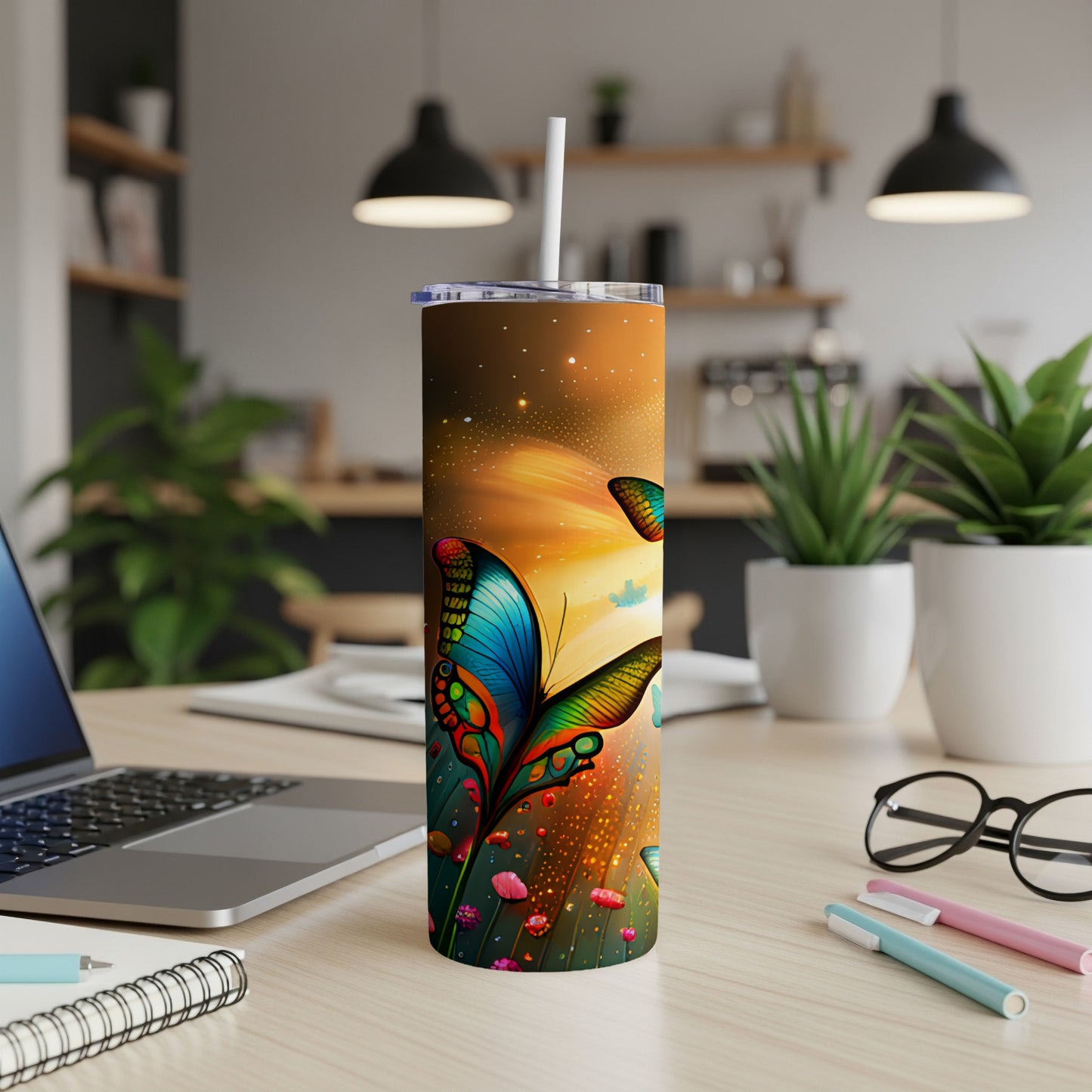 Colorful butterfly illustration on a stainless steel tumbler with a straw.