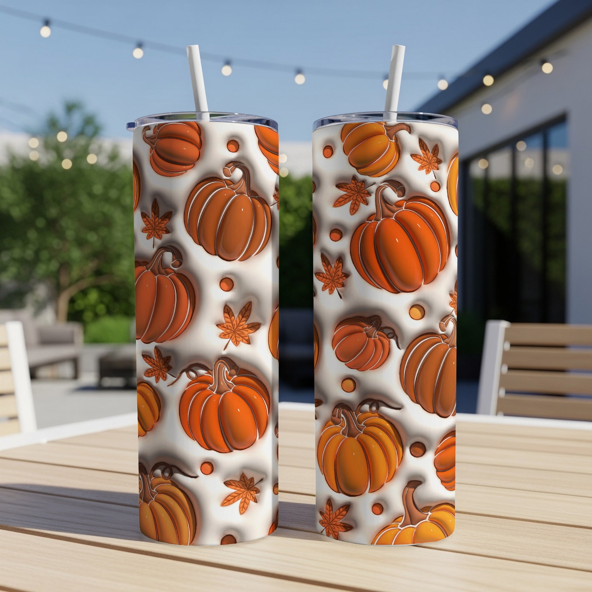 Two tumblers with a repeating pattern of pumpkins and autumn leaves.