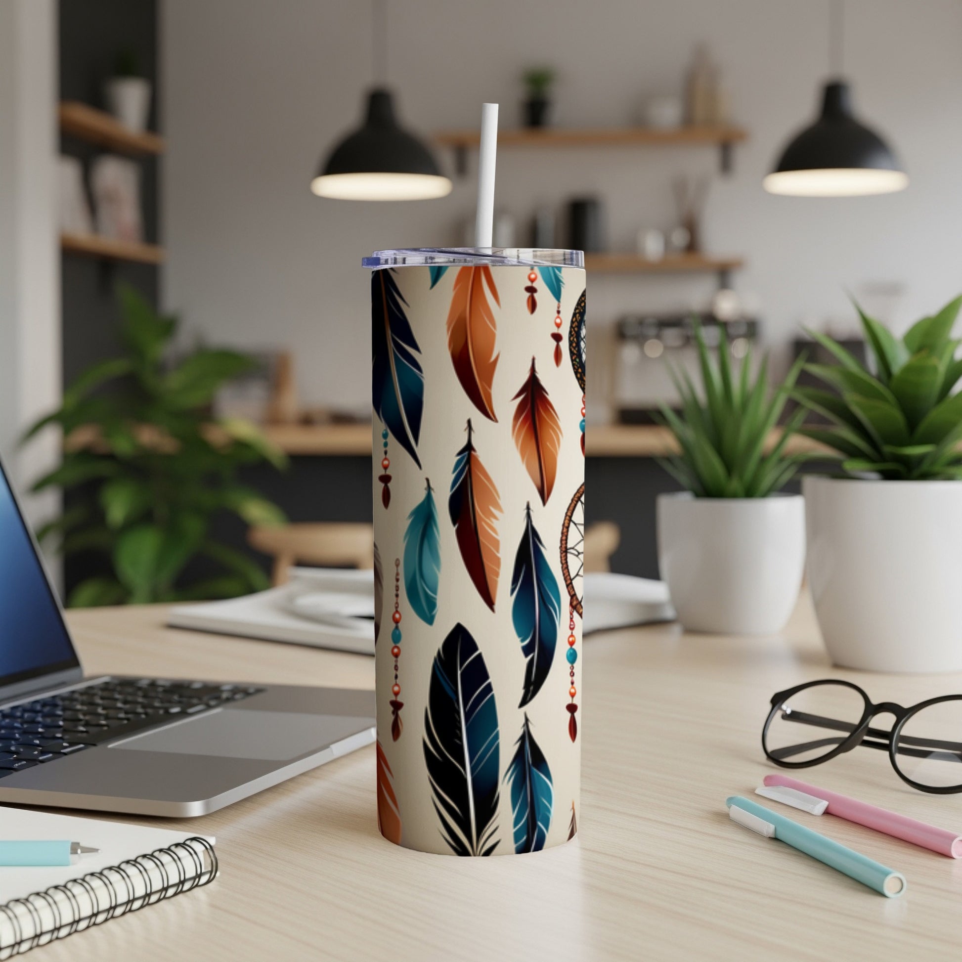 Beige tumbler with feathers and dreamcatcher pattern, lid, and straw.
