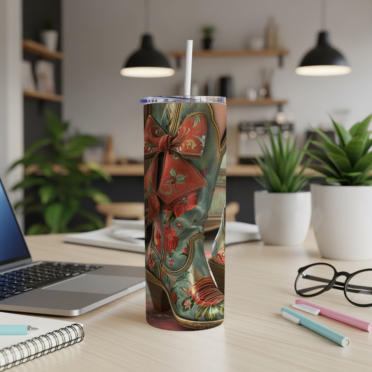 Cowboy boot graphic tumbler with red bow and floral details.