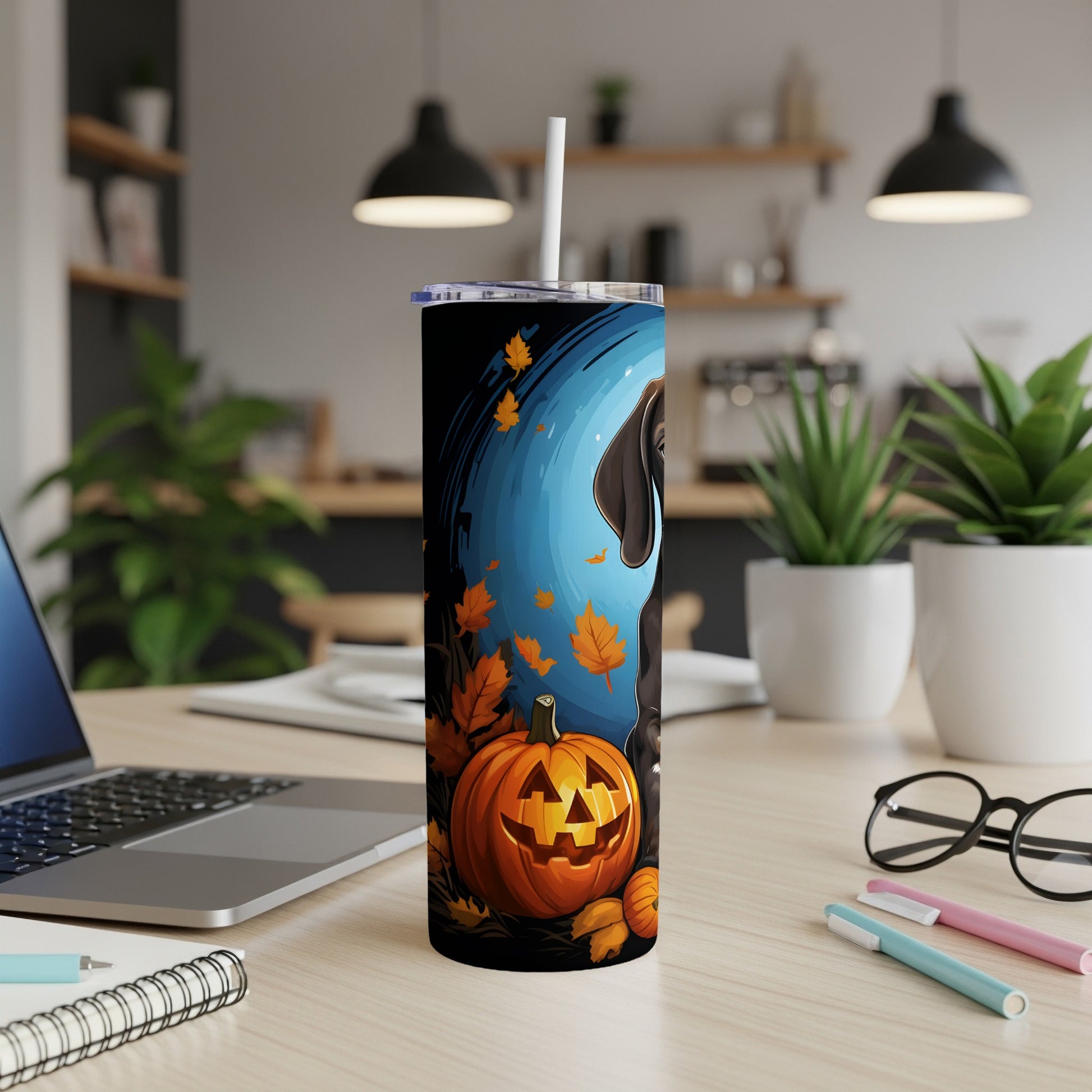 Black tumbler with pumpkin, dog, and falling leaves Halloween design.