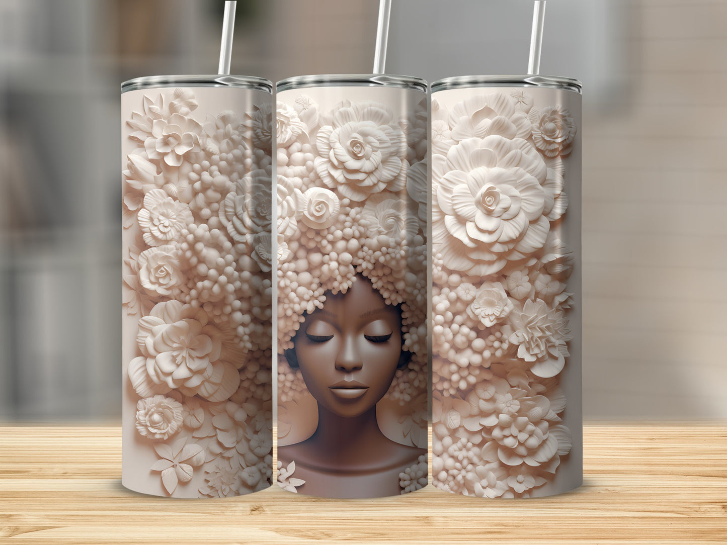 Three tumblers featuring a woman's face with floral hair.