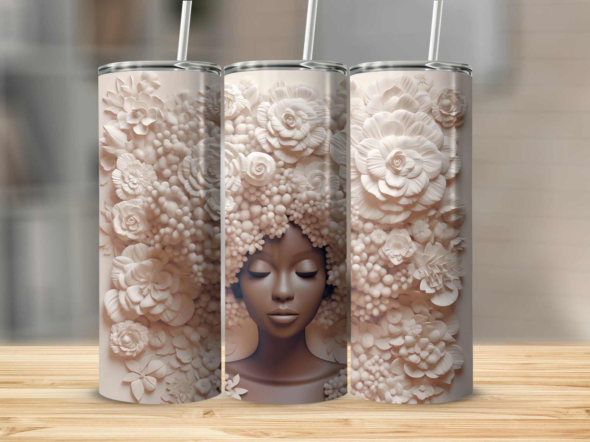 Three tumblers featuring a woman's face with floral hair.