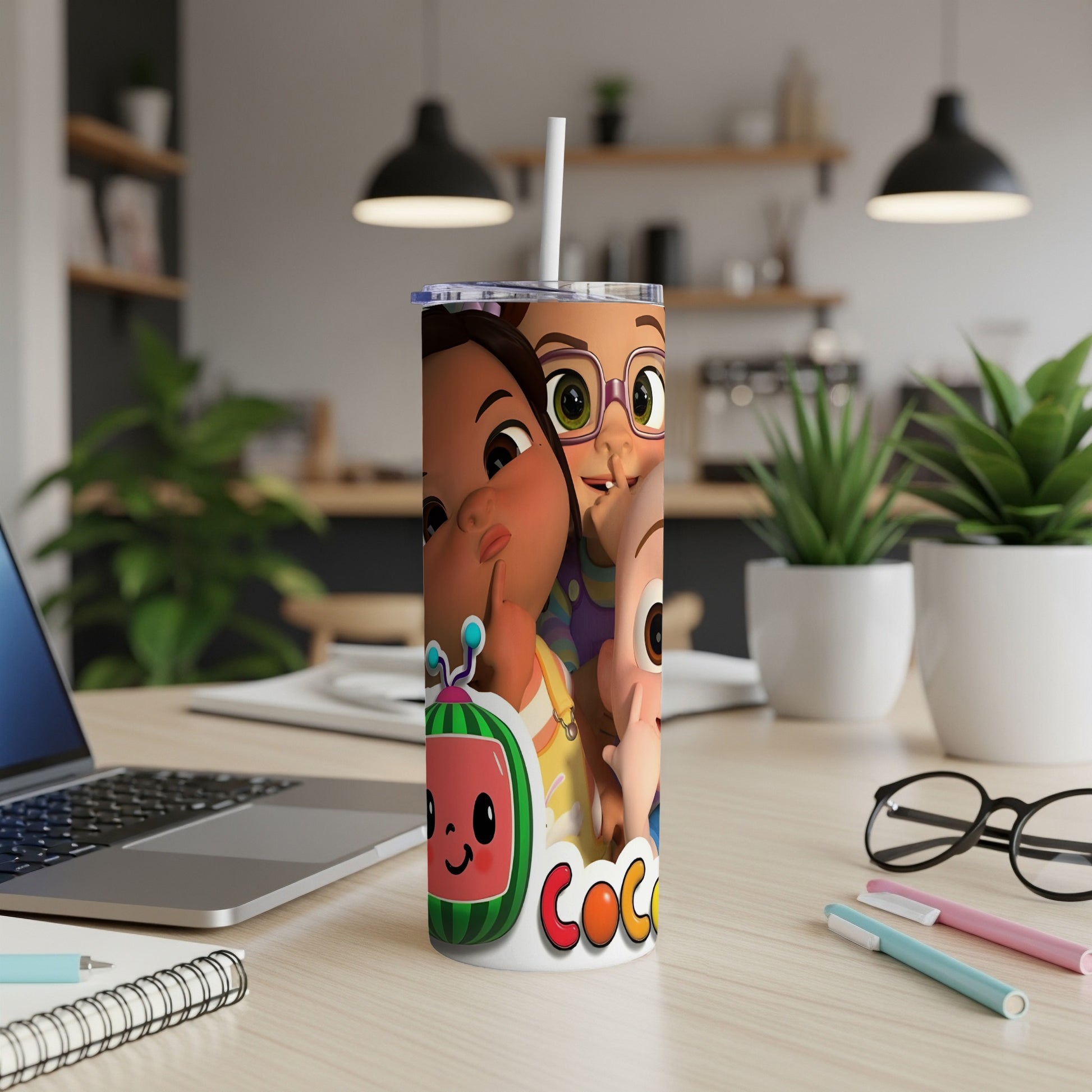 Cocomelon characters on a white tumbler with straw, on a desk.