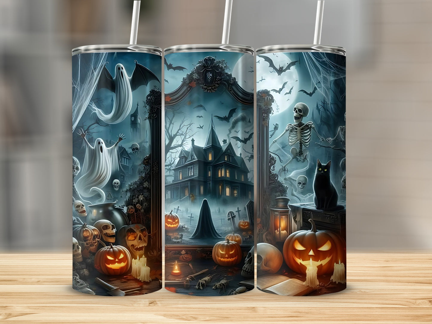 Three tumblers with Halloween art: ghosts, haunted house, pumpkins, and skeletons.