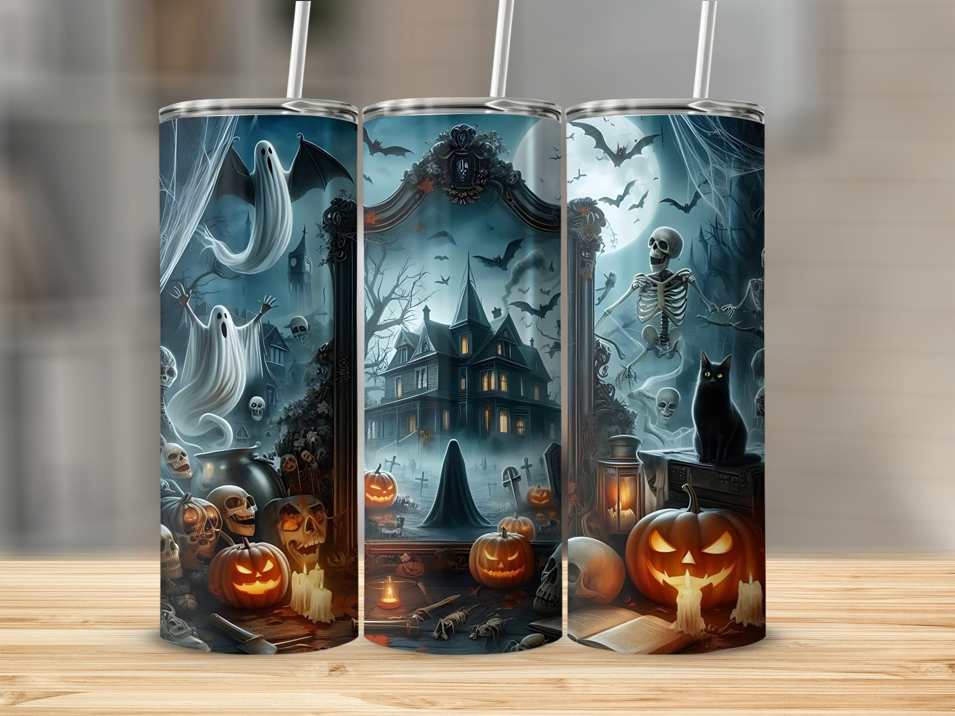 Three tumblers with Halloween art: ghosts, haunted house, pumpkins, and skeletons.