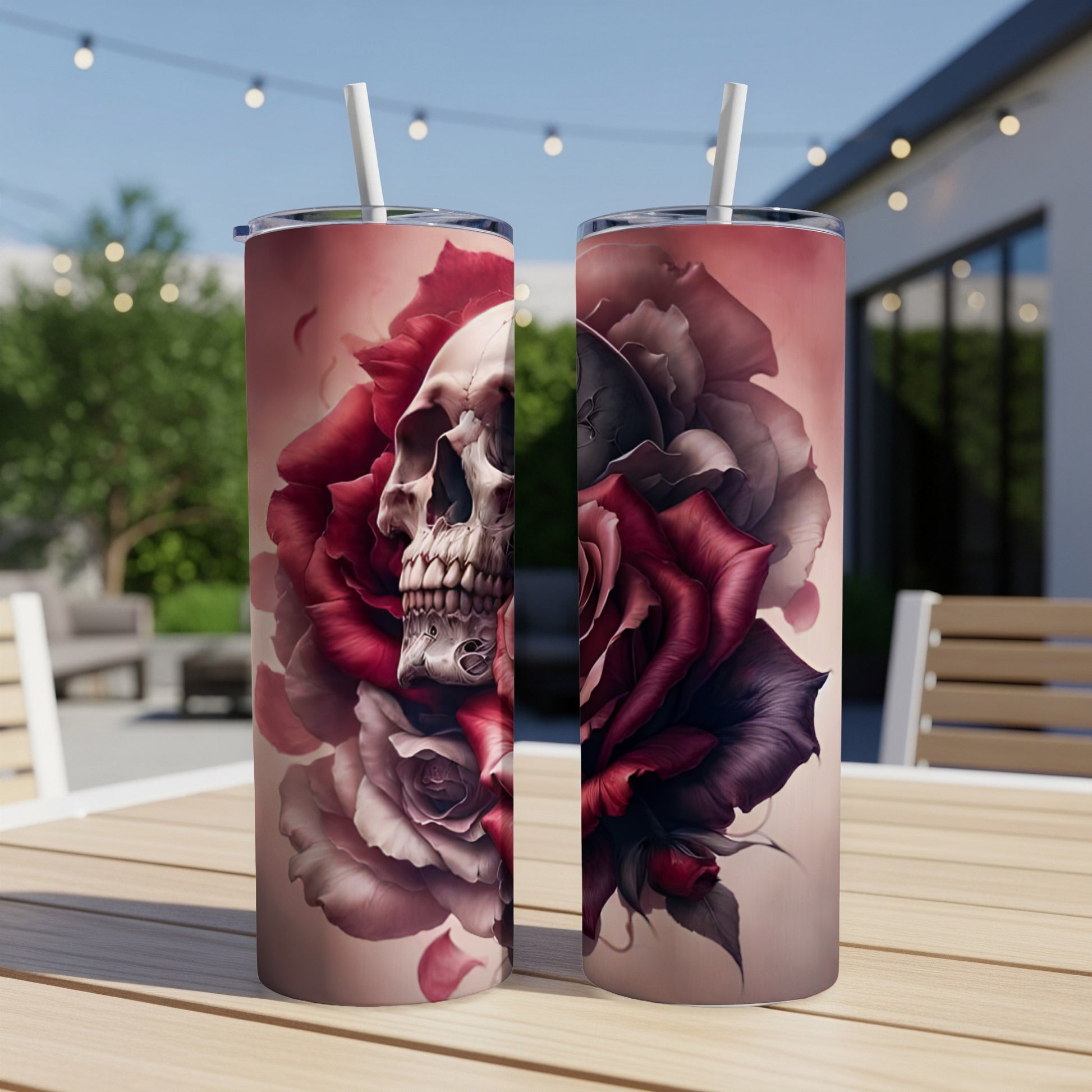 Two tumblers with skull and rose designs on a wooden table.