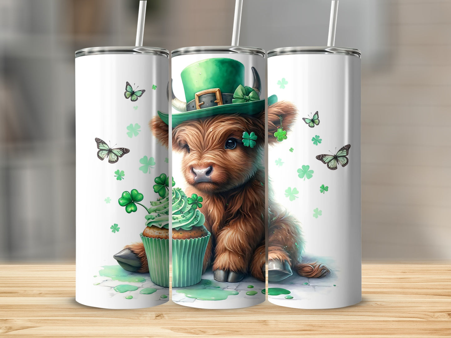 Highland cow wearing a St. Patrick's Day hat with a cupcake and shamrocks.