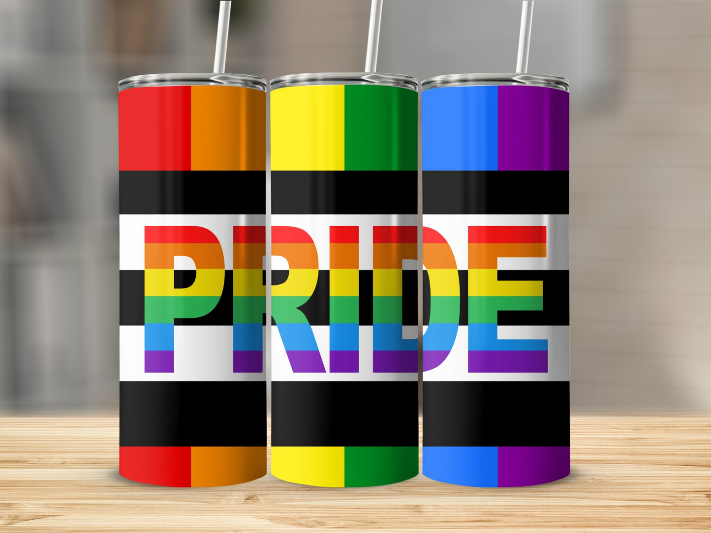 Three tall tumblers with LGBTQ+ pride flag stripes and the word "PRIDE" in rainbow letters.